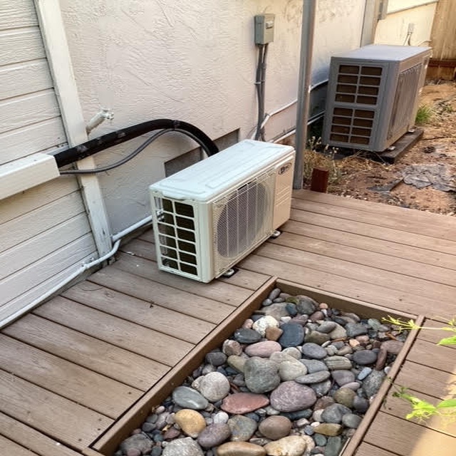 Air conditioning unit installed on wooden deck next to another unit, showcasing HVAC installation and maintenance services offered by Dale-Air in San Diego.